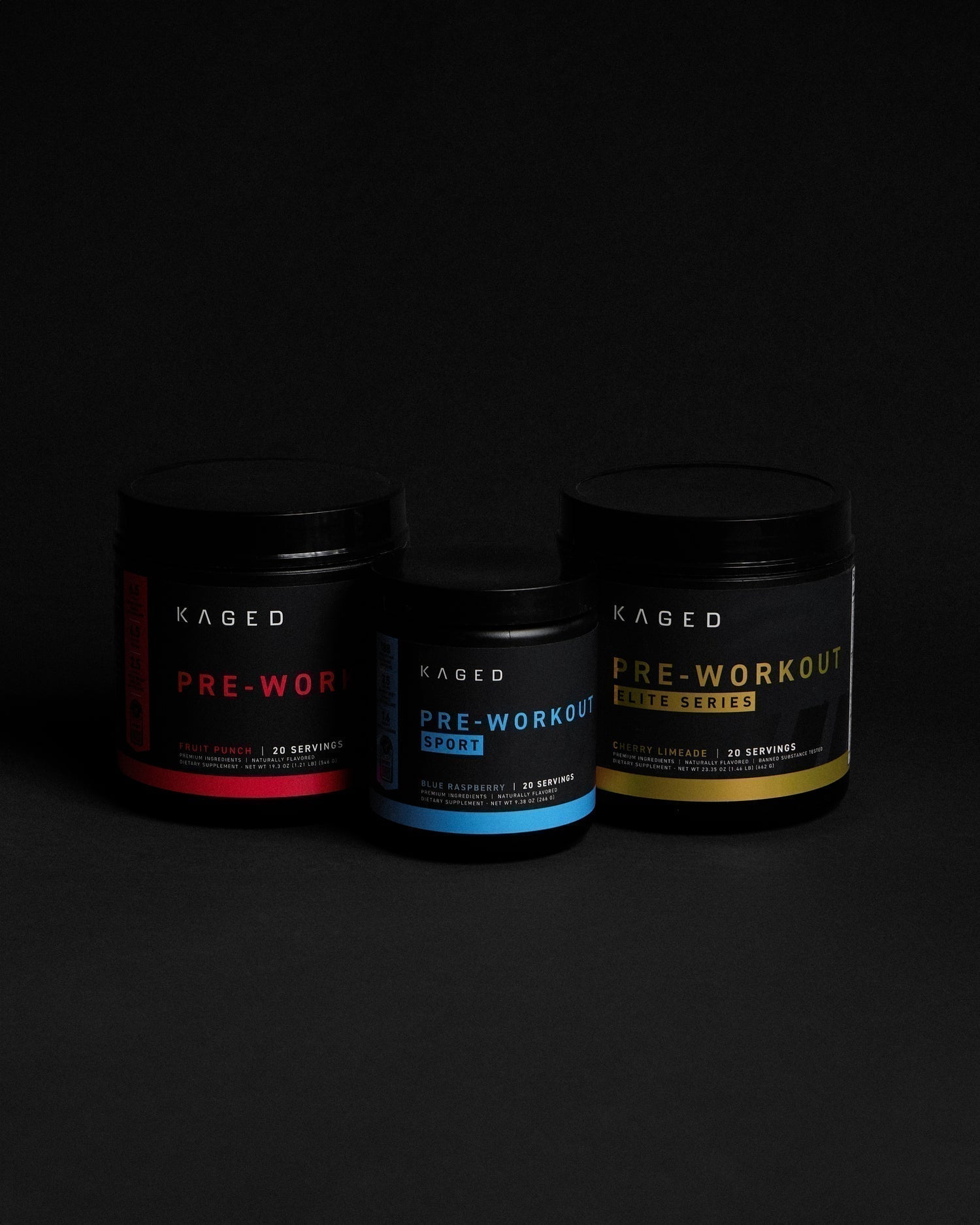 Front view of three KAGED pre workout tubs showing red, blue, and gold label variants on a black background