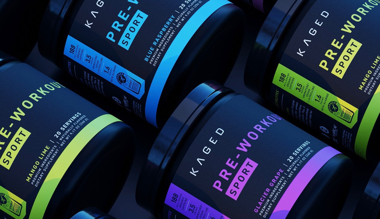 Colorful tubs of Kaged Pre-Workout Sport in multiple flavors arranged in a bold, high-impact flat lay.