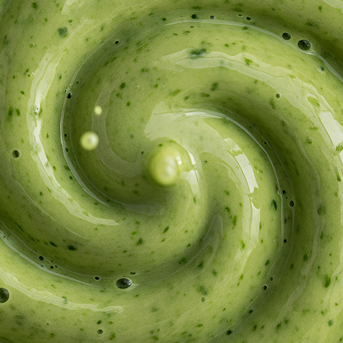 Close-up of Organic Cleanse & Detox blend showcasing creamy green swirl texture with herb flecks
