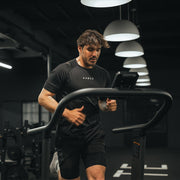 Male Kaged athlete running on a treadmill